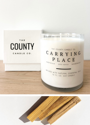 Open image in slideshow, Carrying Place hand-poured cedar wood, palo santo, and sandalwood premium soy candle in a clear glass jar, made by The County Candle Co.  Hand-poured and made from 100% premium soy wax, cotton wicks, and phthalate-free fragrances infused with essential oils, we pride ourselves on creating luxurious candles using time-honored technique and eco-conscious materials. Made in Prince Edward County, Ontario, Canada. 
