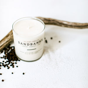 Sandbanks hand-poured teakwood, peppercorn, amber premium soy candle in a clear glass jar made by The County Candle Co.  Hand-poured and made from 100% premium soy wax, cotton wicks, and phthalate-free fragrances infused with essential oils, we pride ourselves on creating luxurious candles using time-honored technique and eco-conscious materials. Made in Prince Edward County, Ontario, Canada. 