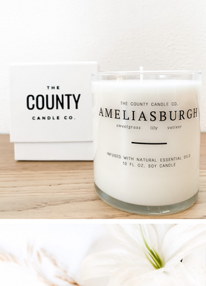 Open image in slideshow, Ameliasburgh hand-poured sweetgrass, lily, and vetiver premium soy candle in a clear glass jar made by The County Candle Co.  Hand-poured and made from 100% premium soy wax, cotton wicks, and phthalate-free fragrances infused with essential oils, we pride ourselves on creating luxurious candles using time-honored technique and eco-conscious materials. Made in Prince Edward County, Ontario, Canada. 
