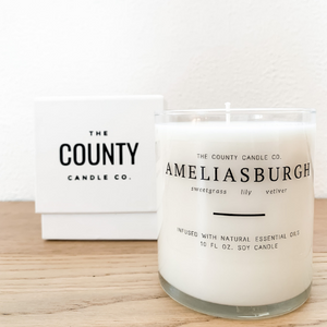 Ameliasburgh hand-poured sweetgrass, lily, and vetiver premium soy candle in a clear glass jar made by The County Candle Co.  Hand-poured and made from 100% premium soy wax, cotton wicks, and phthalate-free fragrances infused with essential oils, we pride ourselves on creating luxurious candles using time-honored technique and eco-conscious materials. Made in Prince Edward County, Ontario, Canada. 