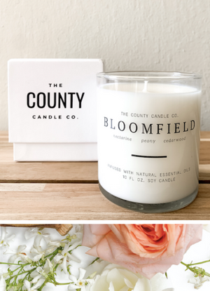 Open image in slideshow, Bloomfield hand-poured nectarine, peony, and cedar wood premium soy candle in a clear glass jar made by The County Candle Co.  Hand-poured and made from 100% premium soy wax, cotton wicks, and phthalate-free fragrances infused with essential oils, we pride ourselves on creating luxurious candles using time-honored technique and eco-conscious materials. Made in Prince Edward County, Ontario, Canada. 
