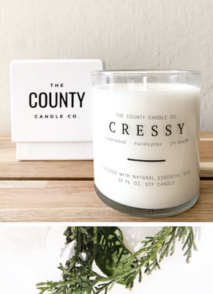 Open image in slideshow, Cressy hand-poured cedar wood, eucalyptus, and fir needle premium soy candle in a clear glass jar made by The County Candle Co.  Hand-poured and made from 100% premium soy wax, cotton wicks, and phthalate-free fragrances infused with essential oils, we pride ourselves on creating luxurious candles using time-honored technique and eco-conscious materials. Made in Prince Edward County, Ontario, Canada. 
