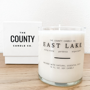 East Lake hand-poured ylang ylang, gardenia, and argan bark premium soy candle in a clear glass jar made by The County Candle Co.  Hand-poured and made from 100% premium soy wax, cotton wicks, and phthalate-free fragrances infused with essential oils, we pride ourselves on creating luxurious candles using time-honored technique and eco-conscious materials. Made in Prince Edward County, Ontario, Canada. 