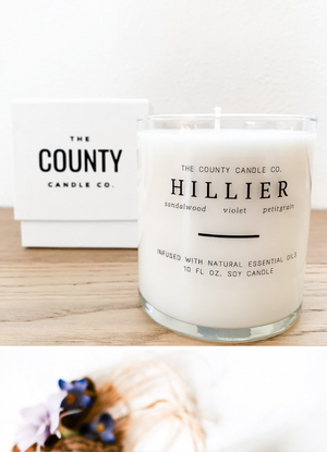 Open image in slideshow, Hillier hand-poured sandalwood, violet, and petitgrain premium soy candle in a clear glass jar made by The County Candle Co.  Hand-poured and made from 100% premium soy wax, cotton wicks, and phthalate-free fragrances infused with essential oils, we pride ourselves on creating luxurious candles using time-honored technique and eco-conscious materials. Made in Prince Edward County, Ontario, Canada. 
