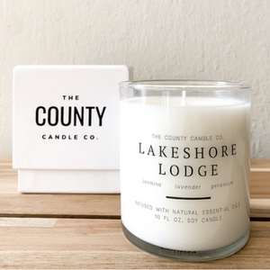 Lakeshore Lodge hand-poured jasmine, lavender, and geranium premium soy candle in a clear glass jar made by The County Candle Co.  Hand-poured and made from 100% premium soy wax, cotton wicks, and phthalate-free fragrances infused with essential oils, we pride ourselves on creating luxurious candles using time-honored technique and eco-conscious materials. Made in Prince Edward County, Ontario, Canada. 