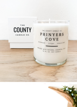 Open image in slideshow, Prinyers Cove hand-poured driftwood, juniper, and tobacco leaf premium soy candle in a clear glass jar, made by The County Candle Co.  Hand-poured and made from 100% premium soy wax, cotton wicks, and phthalate-free fragrances infused with essential oils, we pride ourselves on creating luxurious candles using time-honored technique and eco-conscious materials. Made in Prince Edward County, Ontario, Canada. 
