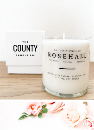 Open image in slideshow, Rosehall hand-poured rose water, hibiscus, and agarwood premium soy candle in a clear glass jar made by The County Candle Co.  Hand-poured and made from 100% premium soy wax, cotton wicks, and phthalate-free fragrances infused with essential oils, we pride ourselves on creating luxurious candles using time-honored technique and eco-conscious materials. Made in Prince Edward County, Ontario, Canada. 
