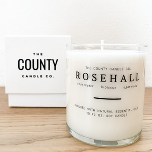 Rosehall hand-poured rose water, hibiscus, and agarwood premium soy candle in a clear glass jar made by The County Candle Co.  Hand-poured and made from 100% premium soy wax, cotton wicks, and phthalate-free fragrances infused with essential oils, we pride ourselves on creating luxurious candles using time-honored technique and eco-conscious materials. Made in Prince Edward County, Ontario, Canada. 