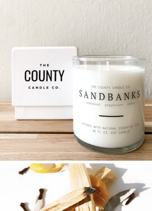 Open image in slideshow, Sandbanks hand-poured teakwood, peppercorn, amber premium soy candle in a clear glass jar made by The County Candle Co.  Hand-poured and made from 100% premium soy wax, cotton wicks, and phthalate-free fragrances infused with essential oils, we pride ourselves on creating luxurious candles using time-honored technique and eco-conscious materials. Made in Prince Edward County, Ontario, Canada. 
