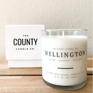 Wellington hand-poured sea salt, cardamom, dark musk premium soy candle in a clear glass jar made by The County Candle Co.  Hand-poured and made from 100% premium soy wax, cotton wicks, and phthalate-free fragrances infused with essential oils, we pride ourselves on creating luxurious candles using time-honored technique and eco-conscious materials. Made in Prince Edward County, Ontario, Canada. 